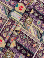 Colorful ethnic patterned fabric with geometric shapes and floral elements on a purple background