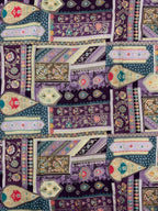 Colorful ethnic patterned fabric with geometric shapes and floral elements on a purple base