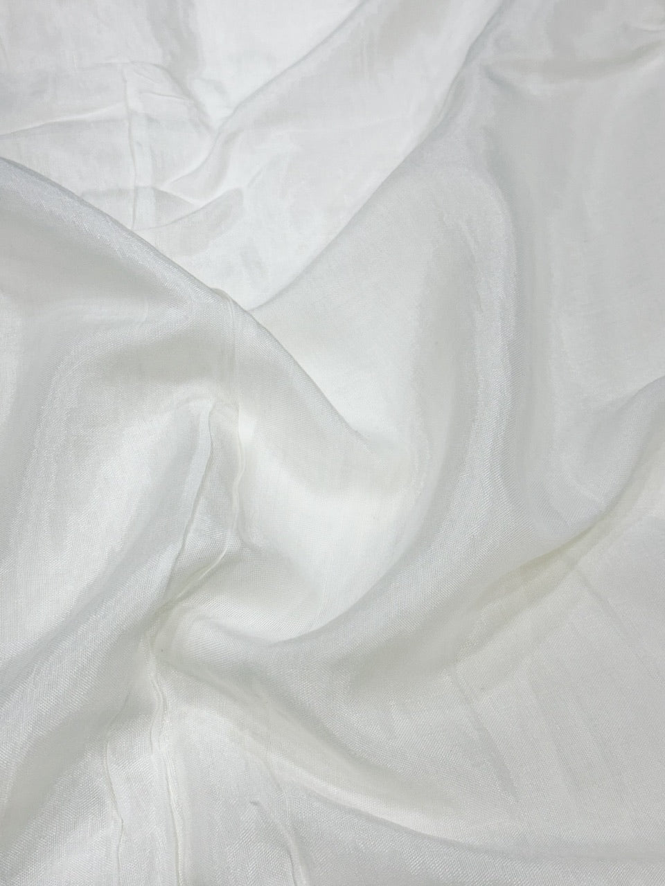 Close-up of white shantoon fabric with a soft texture