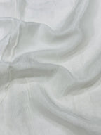 Close-up of white shantoon fabric with folds