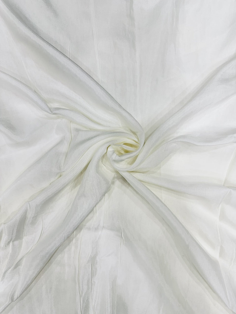 Close-up of white shantoon fabric with a subtle texture