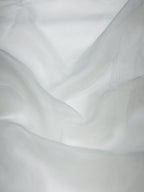 Close-up of white organza fabric with subtle texture