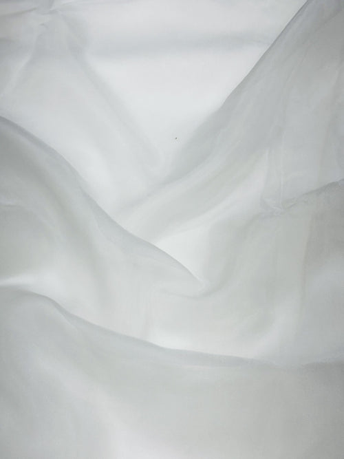 Close-up of white organza fabric with subtle texture
