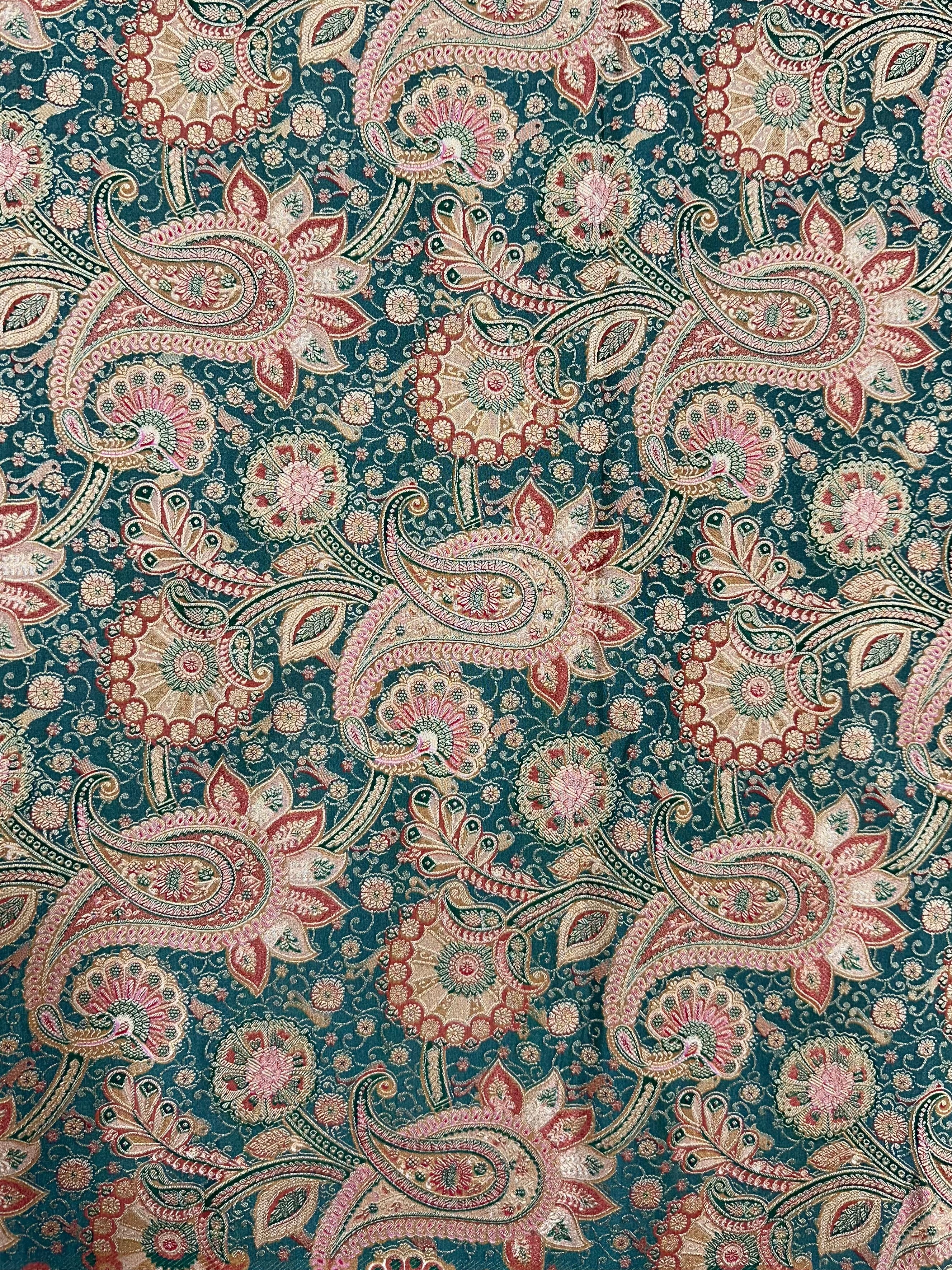Patterned fabric with paisley design on a green background