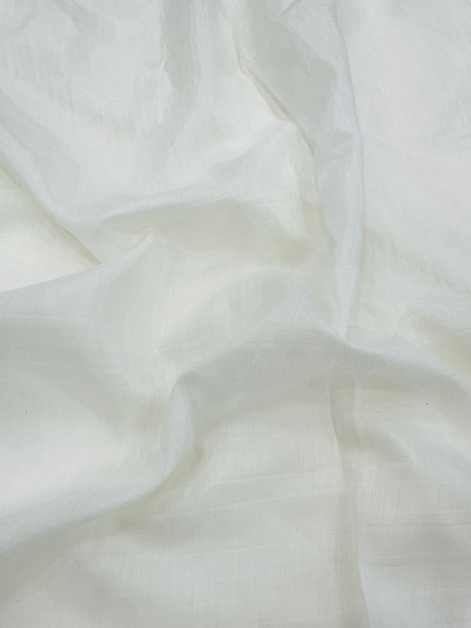 Close-up of white mul chanderi fabric with soft folds