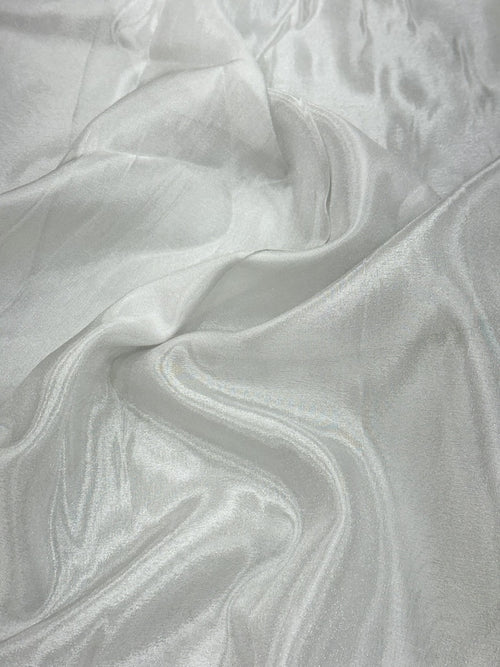 Close-up of silver shimmer tissue fabric with a textured pattern