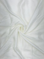Close-up of pure white satin fabric with a swirl pattern