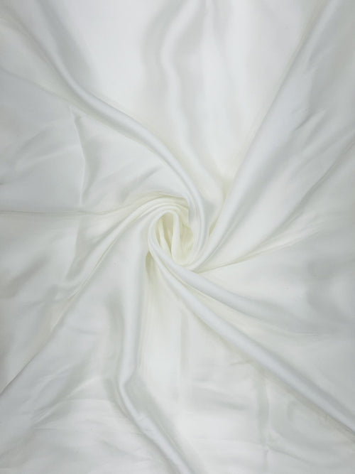 Close-up of pure white satin fabric with a swirl pattern