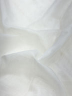Close-up of white soft mul chanderi fabric with folds