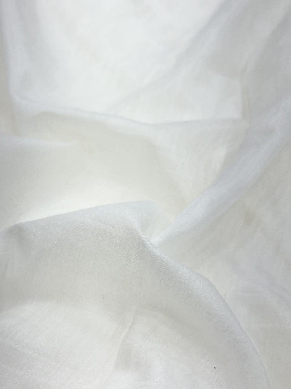 Close-up of white soft mul chanderi fabric with folds