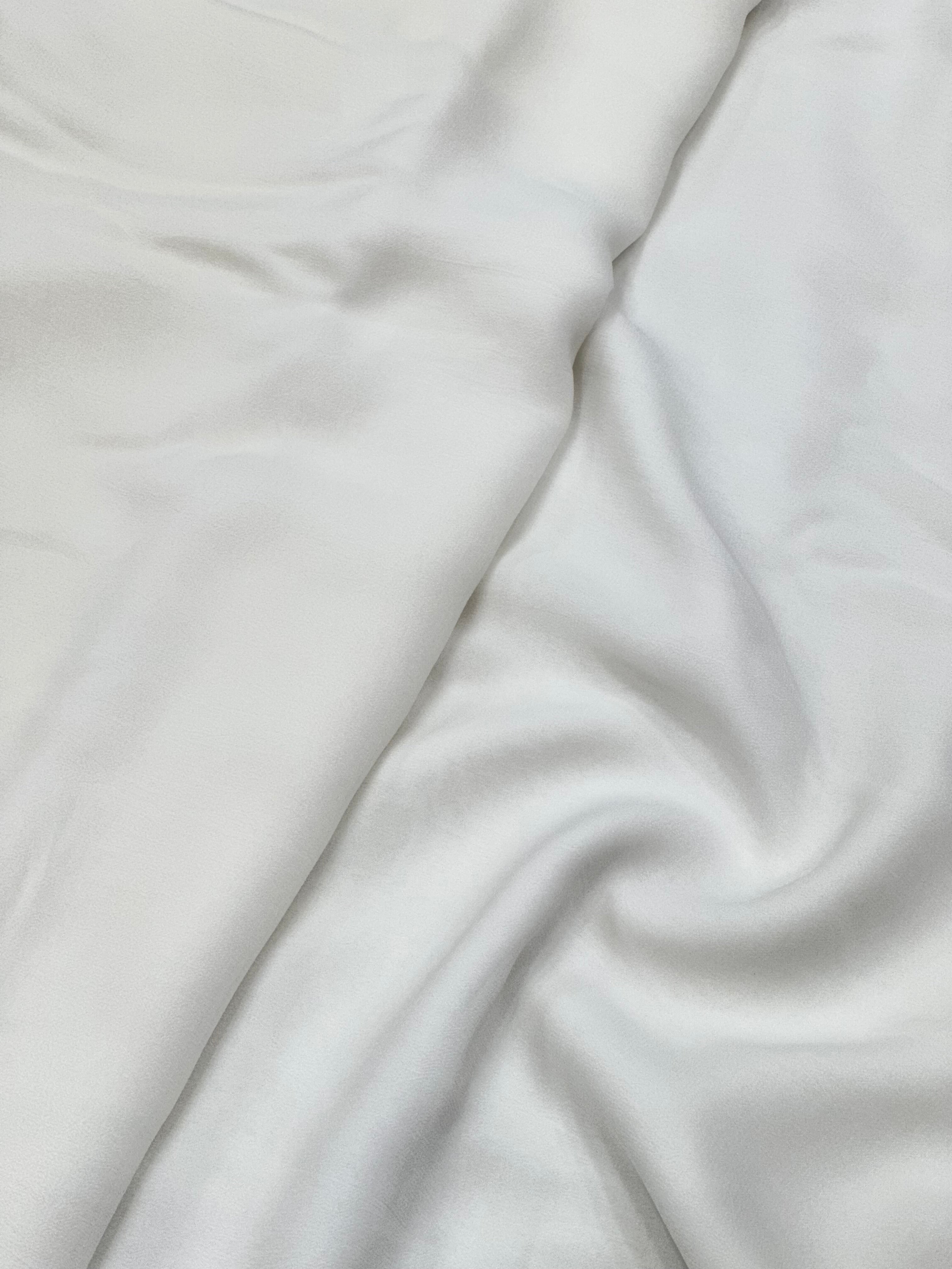 Close-up of white georgette fabric with folds
