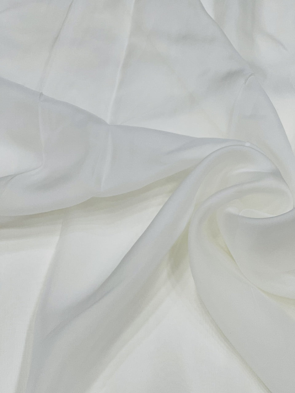 Close-up of white organza fabric with folds