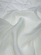 Close-up of white organza fabric with folds