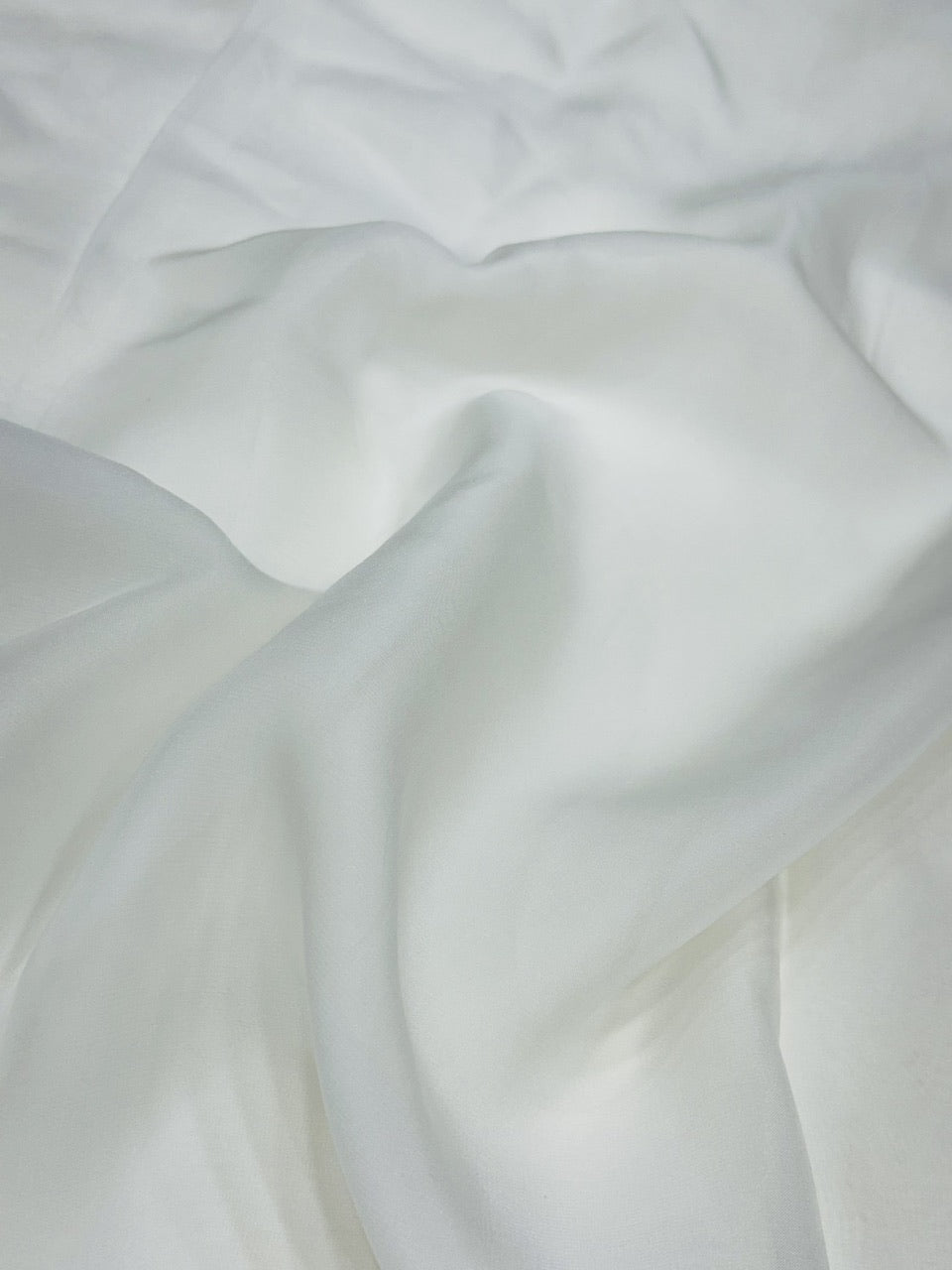 Close-up of white organza fabric with folds