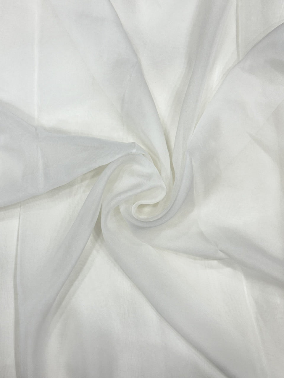 Close-up of white organza fabric with folds