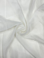 Close-up of white organza fabric with folds