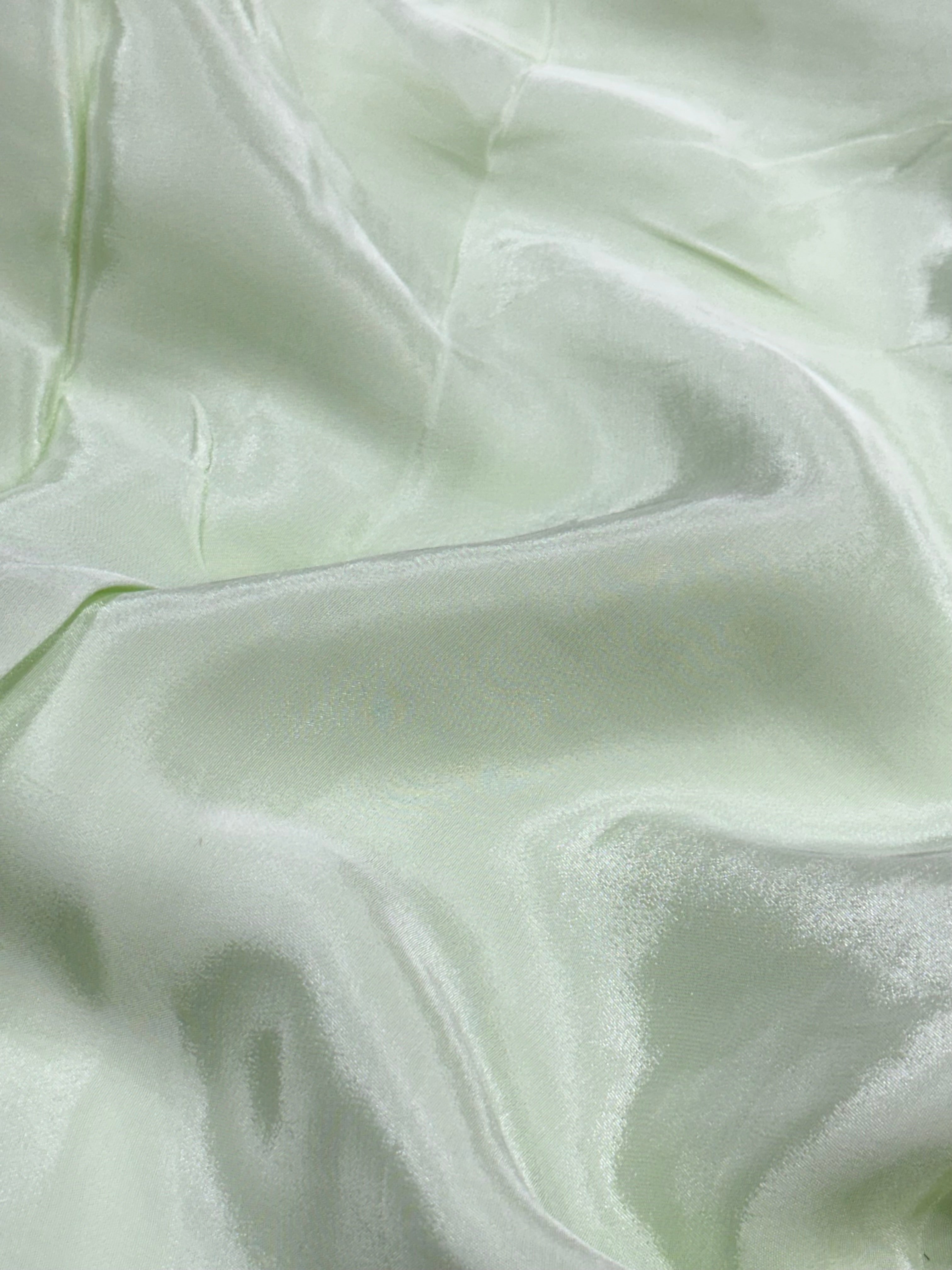Close-up of light green fabric with subtle texture