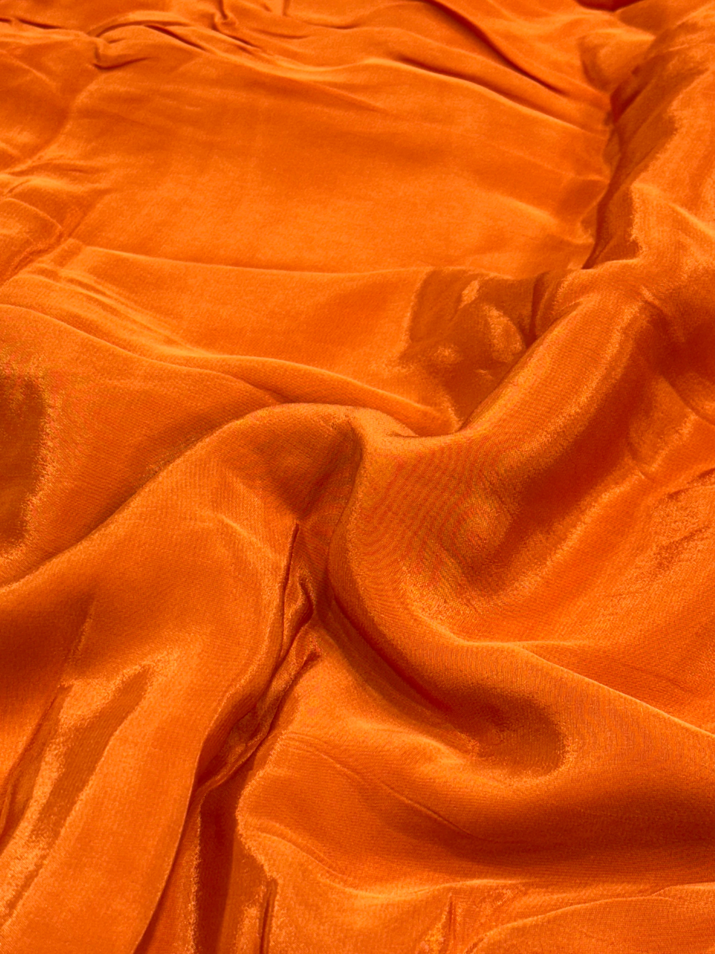 Close-up of rust orange fabric with visible texture