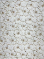 Hand embroidered crepe fabric with circular designs on a white background