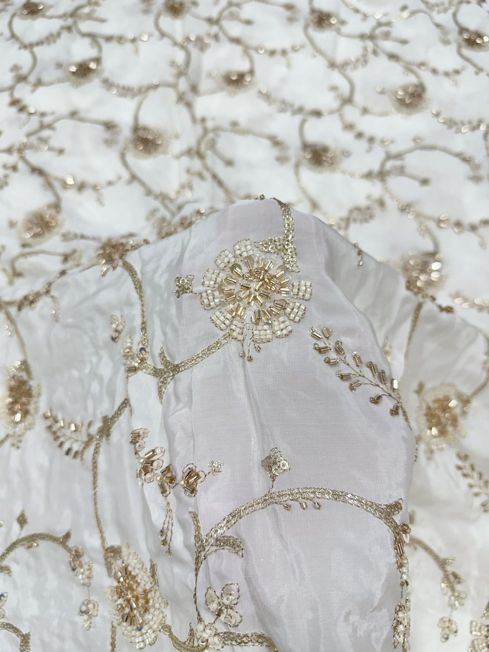 White natural crepe fabric with gold hand beads embroidery