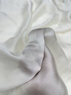 Close-up of white organza satin fabric with folds