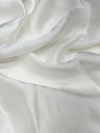 Close-up of white organza satin fabric with soft folds