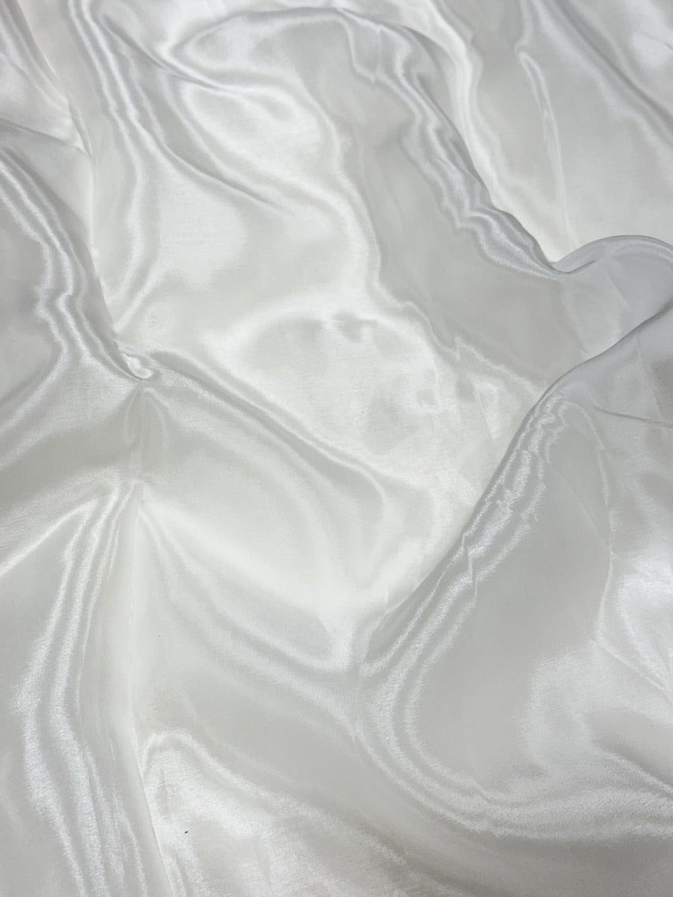 Close-up of white glass organza fabric with a soft texture