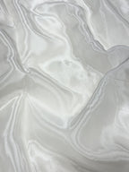 Close-up of white glass organza fabric with a soft texture