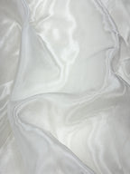 Close-up of white glass organza fabric with folds