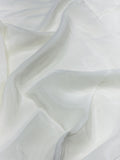 Close-up of white crepe fabric with a soft texture