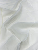 Close-up of white crepe fabric with a soft texture