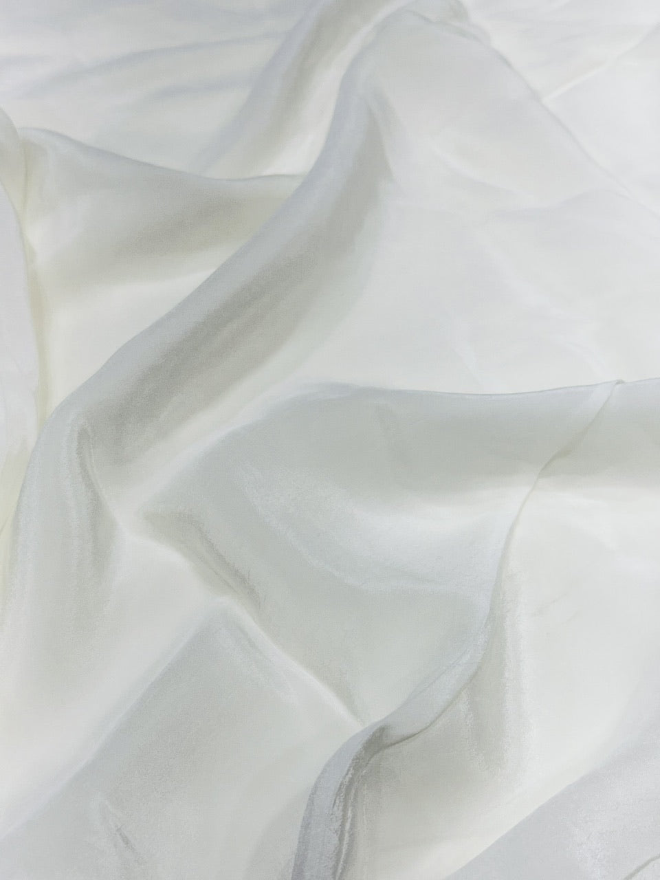 Close-up of white crepe fabric with a soft texture