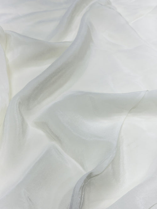 Close-up of white crepe fabric with a soft texture