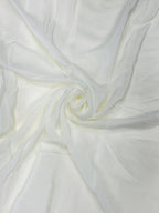 Close-up of white crepe fabric with a subtle texture