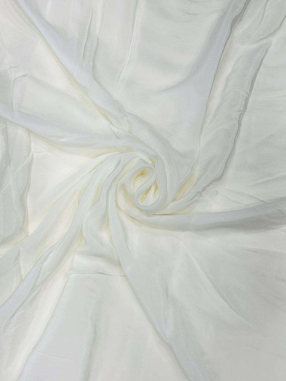Close-up of white crepe fabric with a subtle texture
