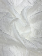 Close-up of white silk fabric with folds