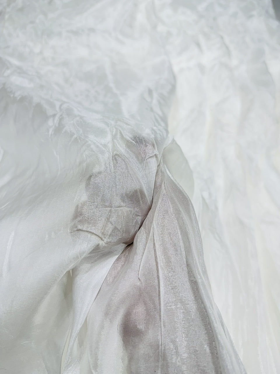 Close-up of white uppada silk fabric with subtle texture