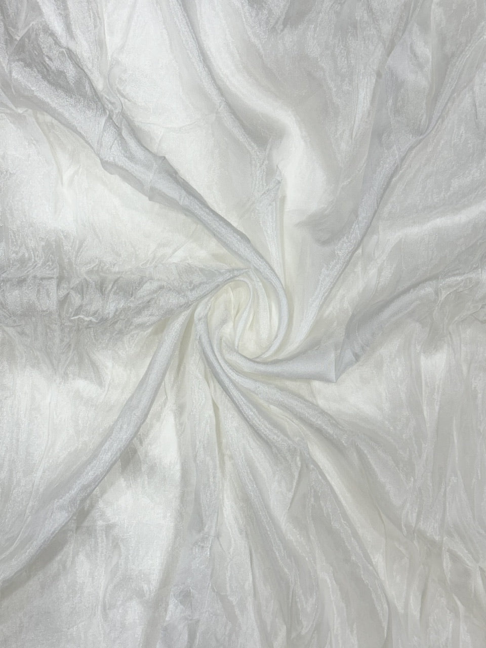 Close-up of white oppada silk fabric with a swirling pattern