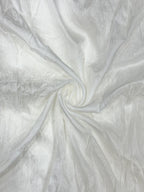Close-up of white oppada silk fabric with a swirling pattern