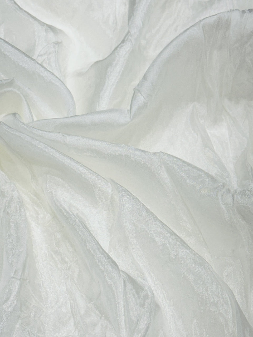 Close-up of white oppada silk fabric with a soft texture