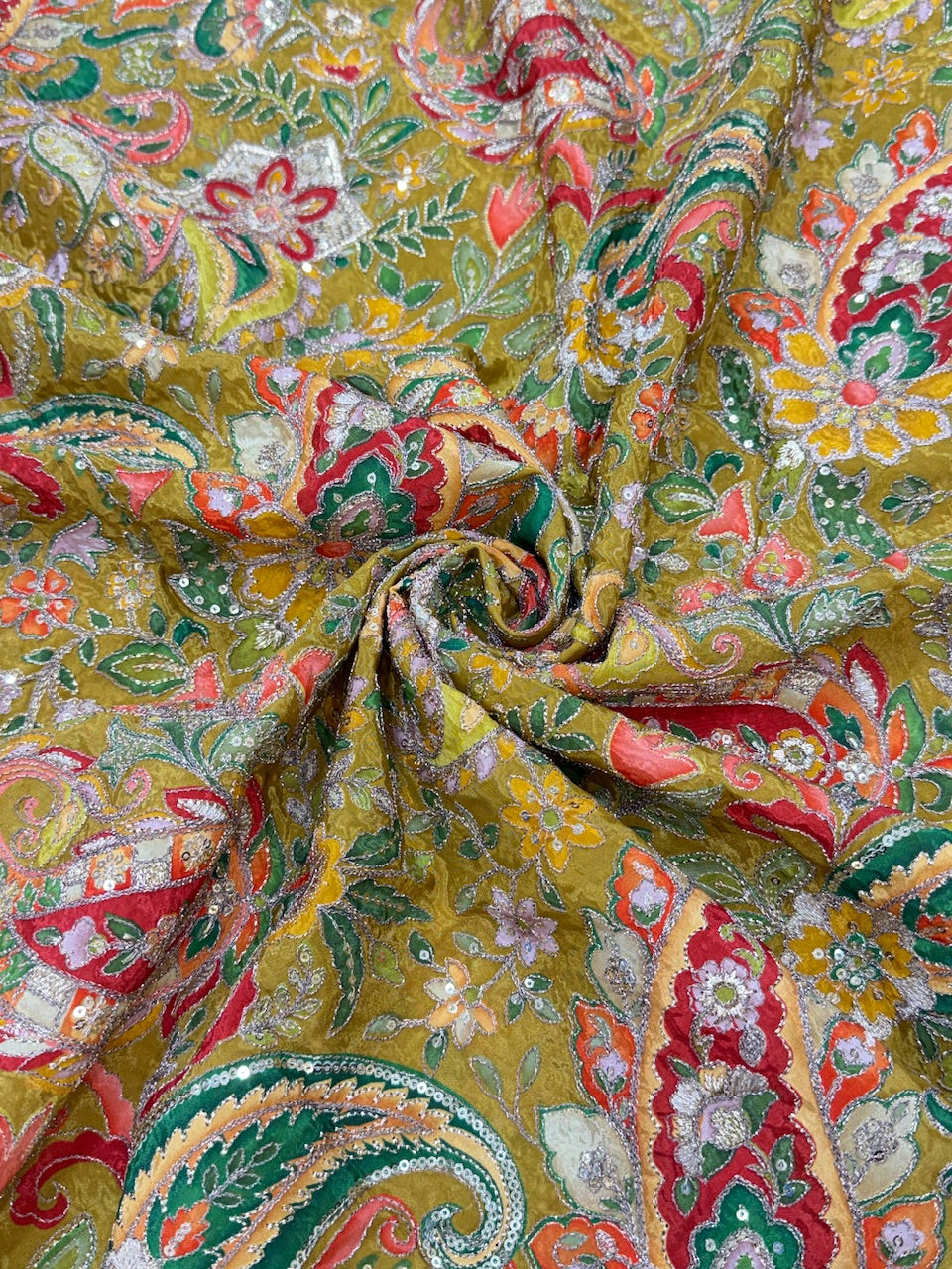 Close-up of intricately patterned fabric with a focus on colors and textures.