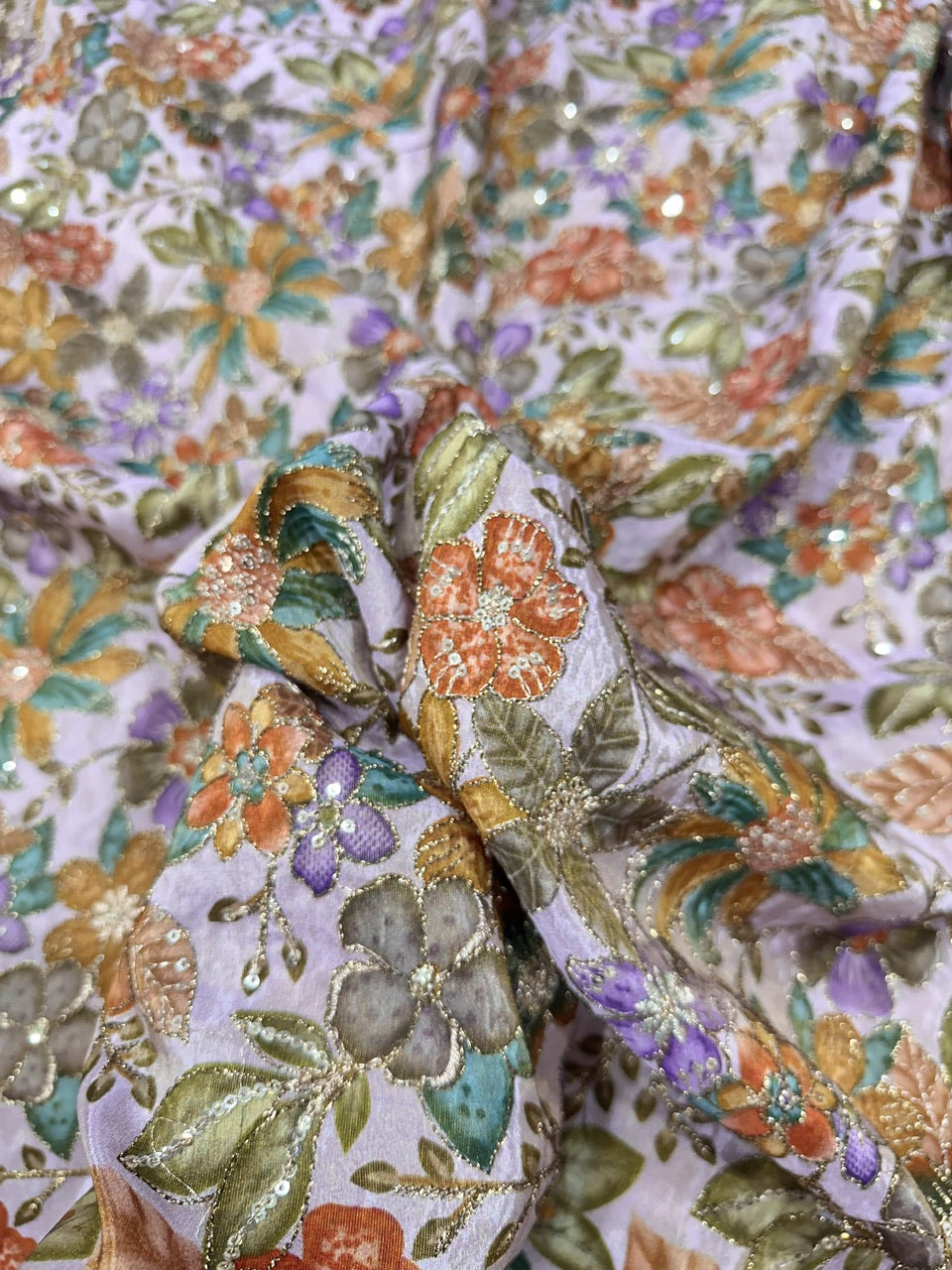 Close-up of a floral fabric with intricate patterns and colors.