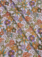 Close-up of floral fabric pattern with multicolor flowers on a light background