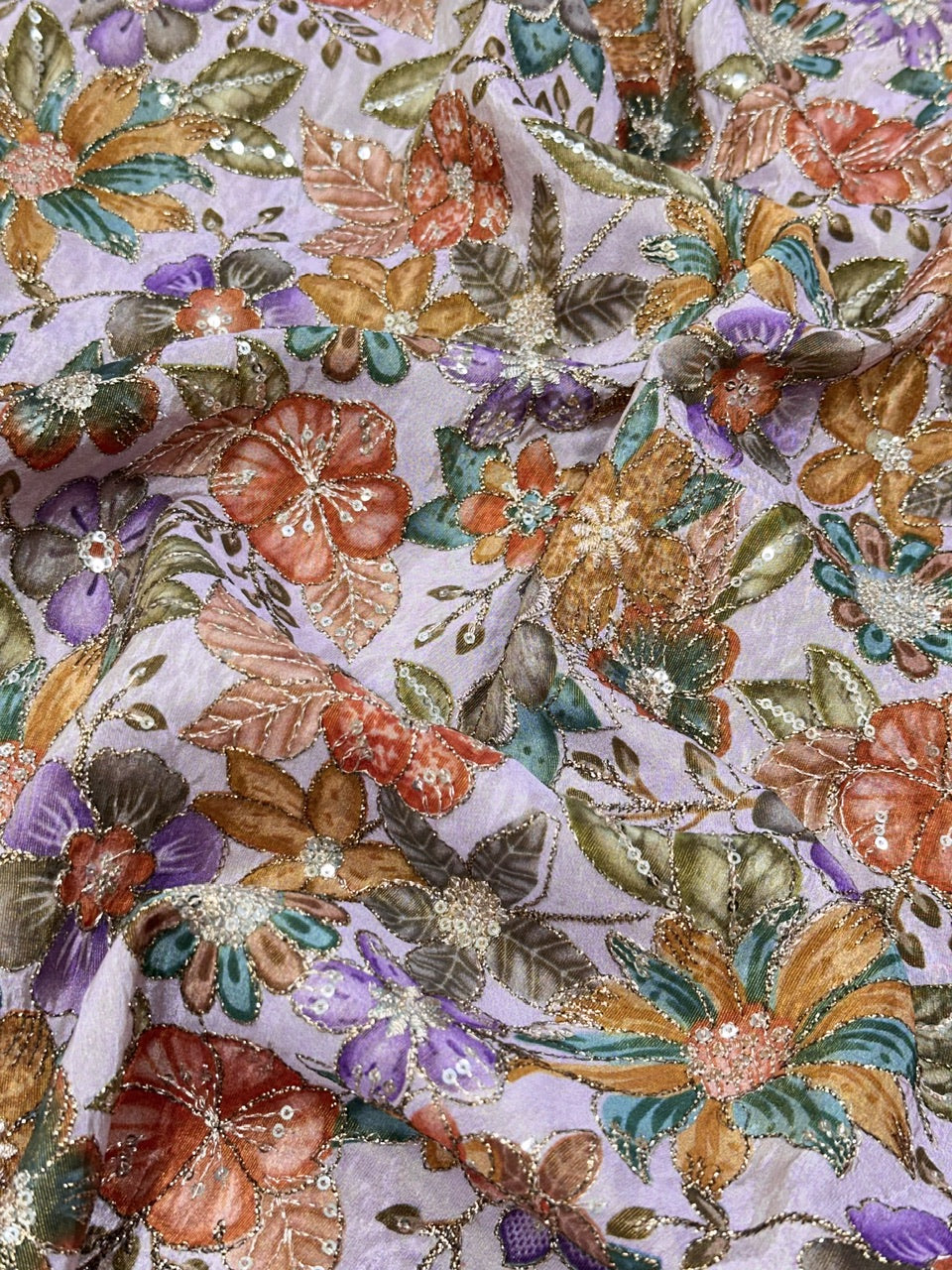 Close-up of floral fabric with multicolor flowers on a light background