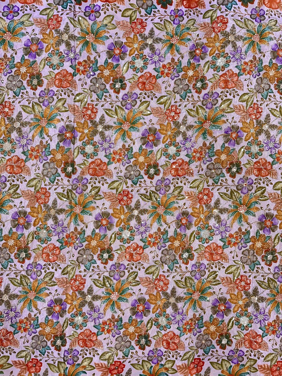Floral patterned fabric with multicolor flowers on a lavender background