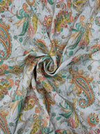 Close-up of paisley patterned fabric with multicolor design on a light background