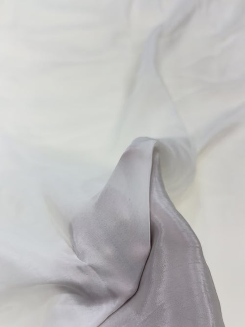 Close-up of white crepe fabric with a soft texture