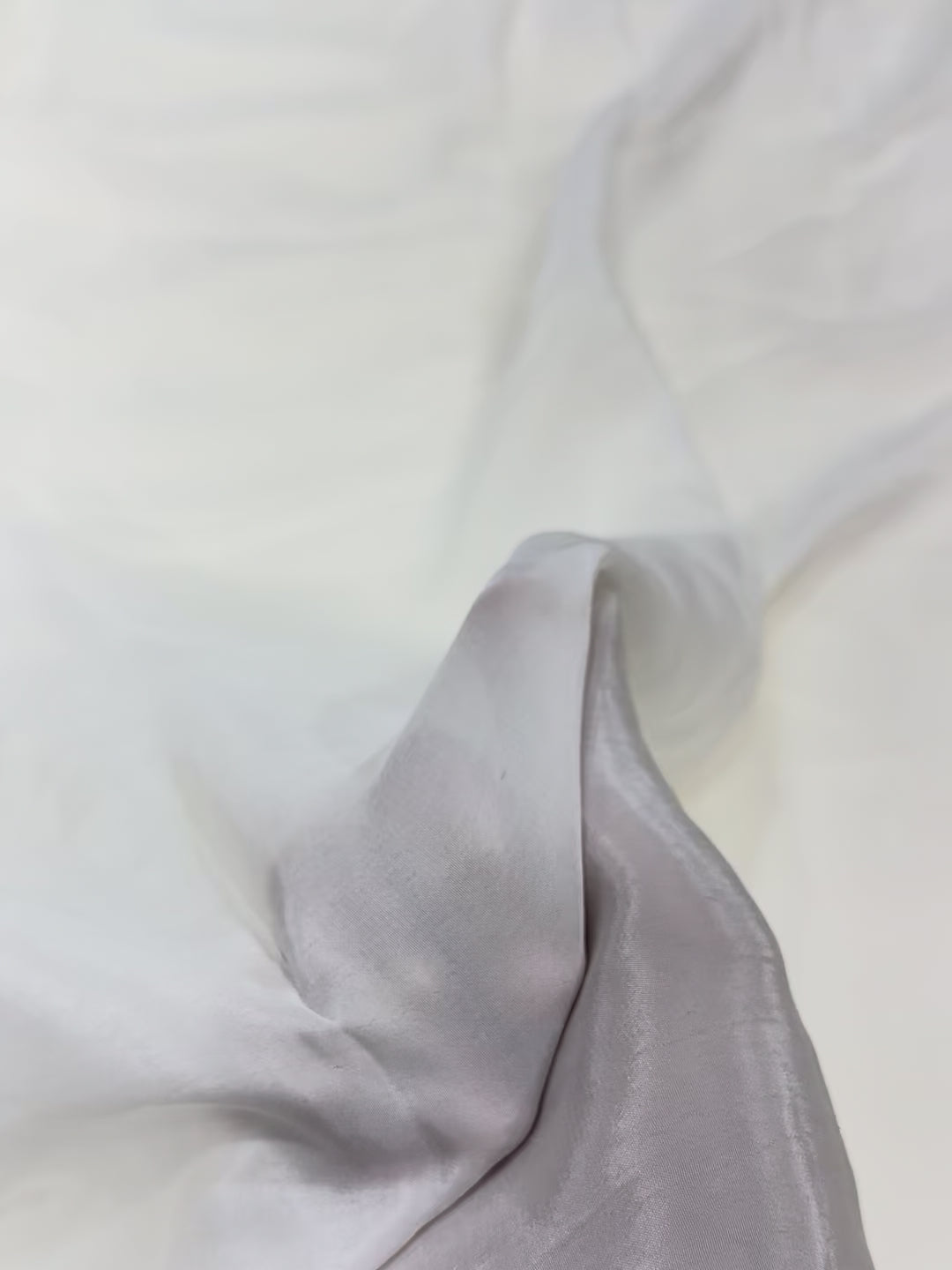Close-up of white crepe fabric with a soft texture