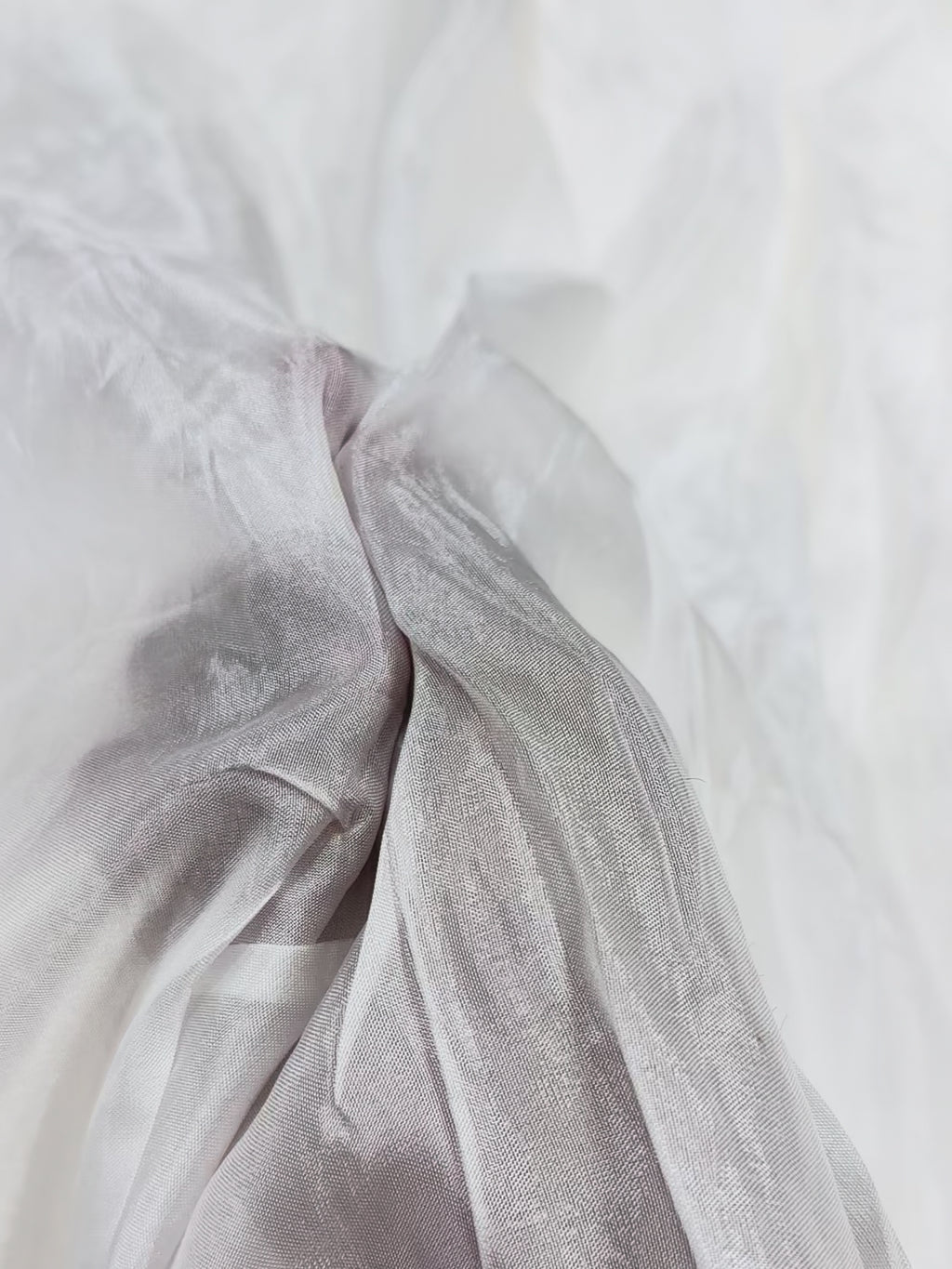 Close-up of white uppada silk fabric with subtle texture