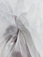 Close-up of white uppada silk fabric with subtle texture